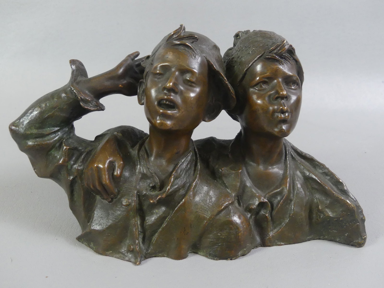 ITALIAN BRONZE OF BOYS SINGING: Antique Italian bronze bust of 2 boys singing, foundry stamp of Diritti Dautore. 10 in long x 5.5 high. Fine condition, chocoate brown patina circa 1900.