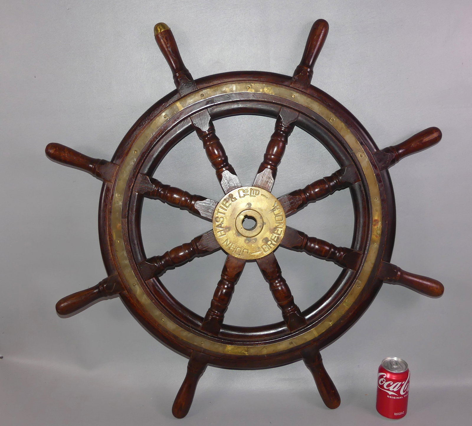 ANTIQUE SHIPS WHEEL: Antique English ship's wheel with brass hub signed John Hastie & Co. Ltd, Greenock. 36 in diameter.