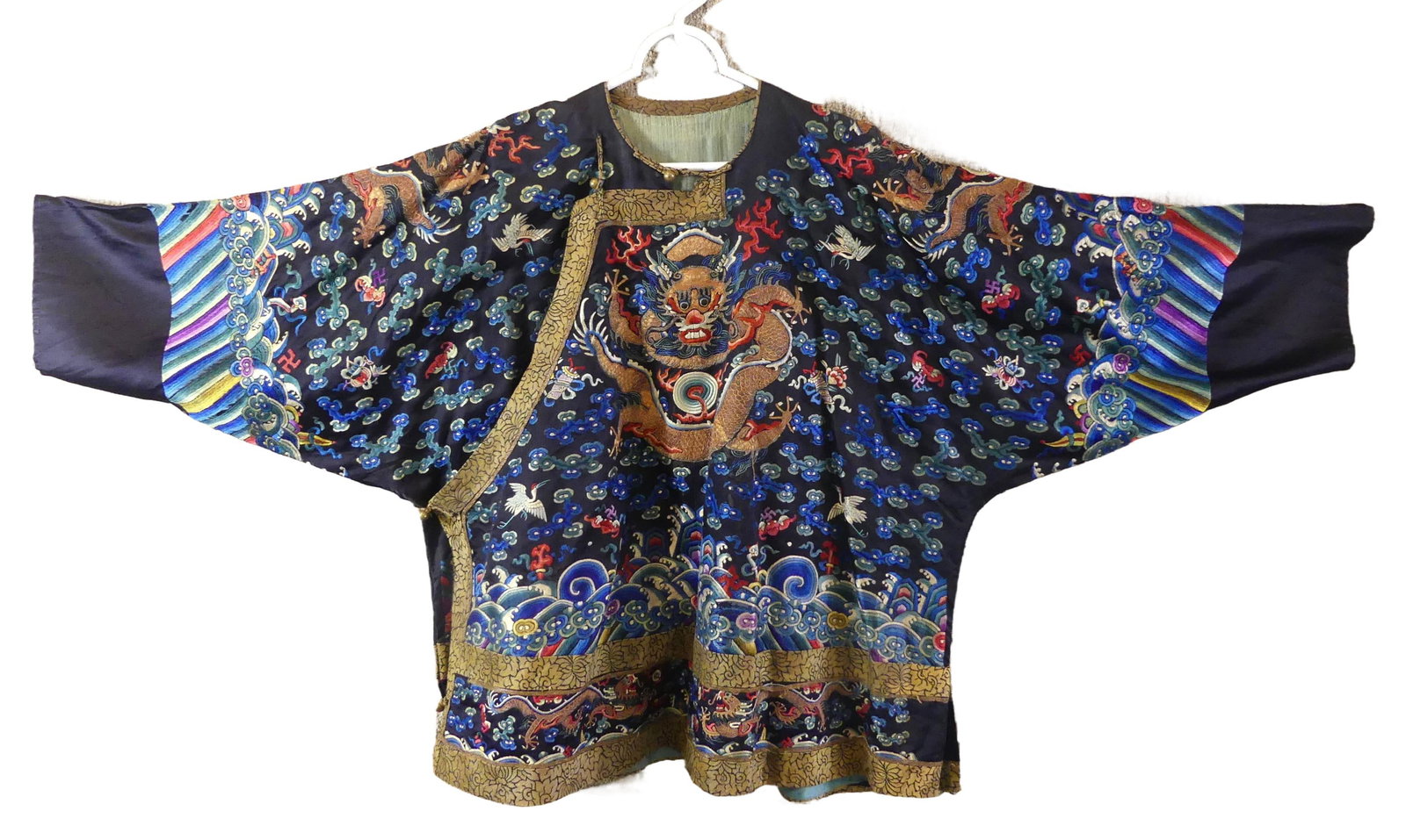 ANTIQUE CHINESE QING SILK ROBE: Fine 19th century cobalt blue Chinese silk robe with dragons, cranes, etc. 56 in by 29 in high. VG condition. Qing Dynasty.