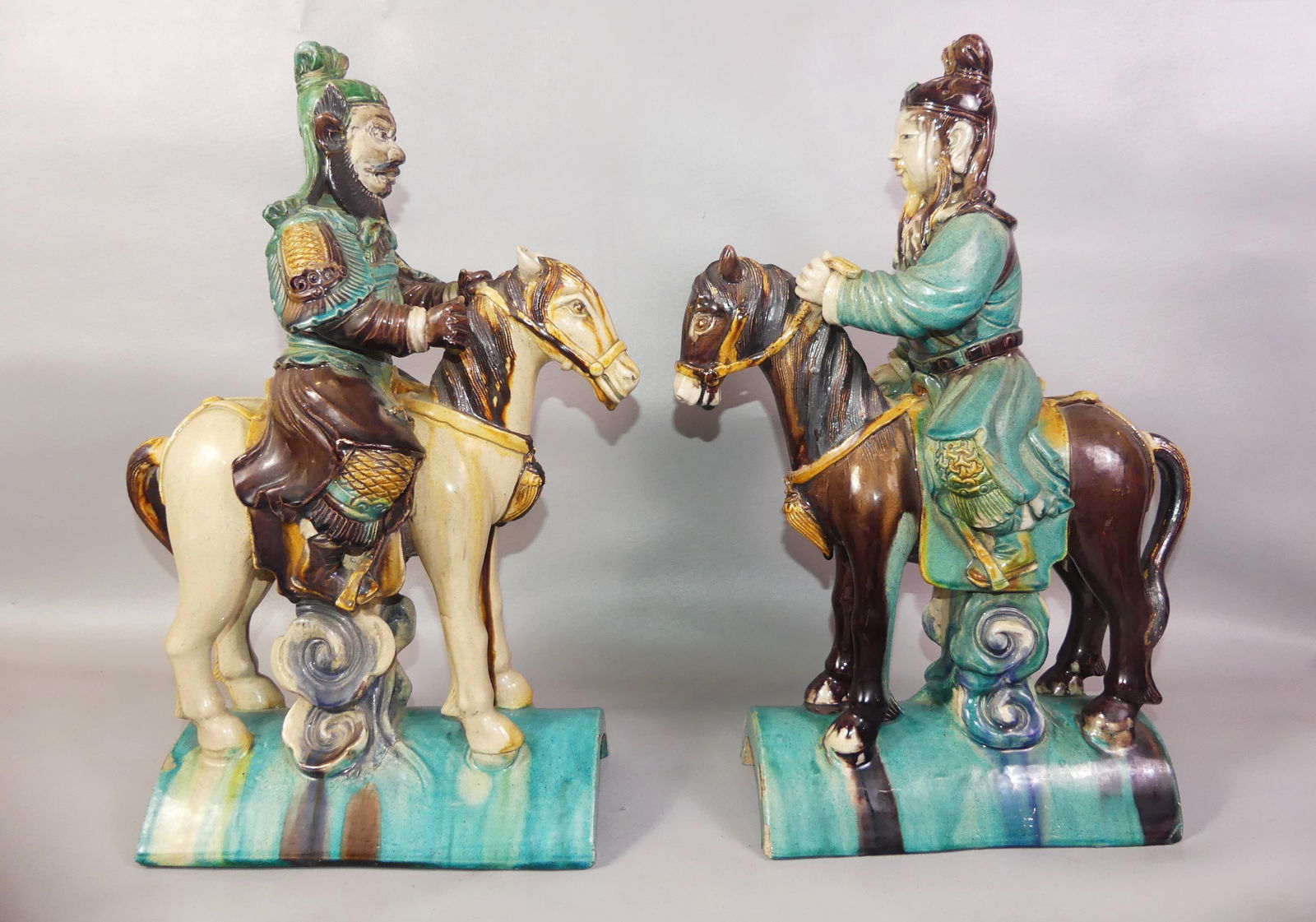 PR. CHINESE ROOF TILES - WARRIORS: Pair of large Chinese glazed pottery roof tiles in the form of Asian warriors on horseback. 18.5 x tall x 10 x 6 in.