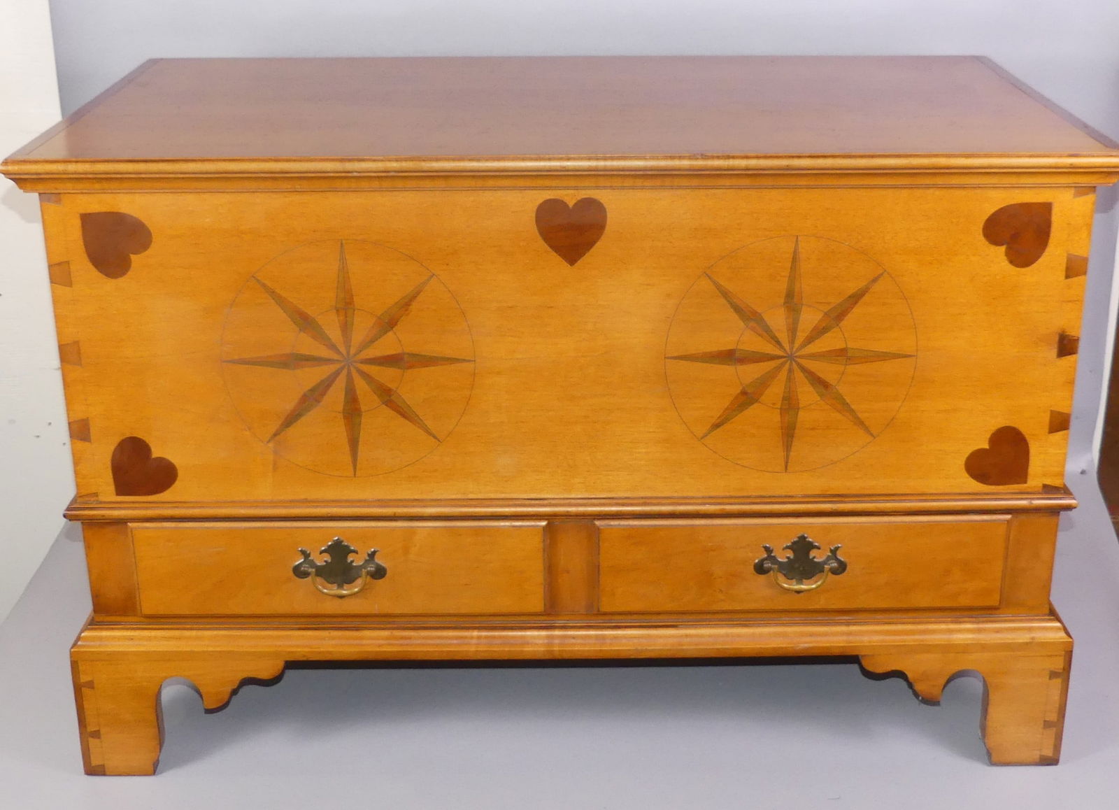 ELDRED WHEELER INLAID CHEST: Fine Eldred Wheeler maple Chippendale blanket chest with inlaid hearts and engraved and colored compass designs. Two lower drawers with Wheeler label inside. Dovetailed construction with bracket feet.