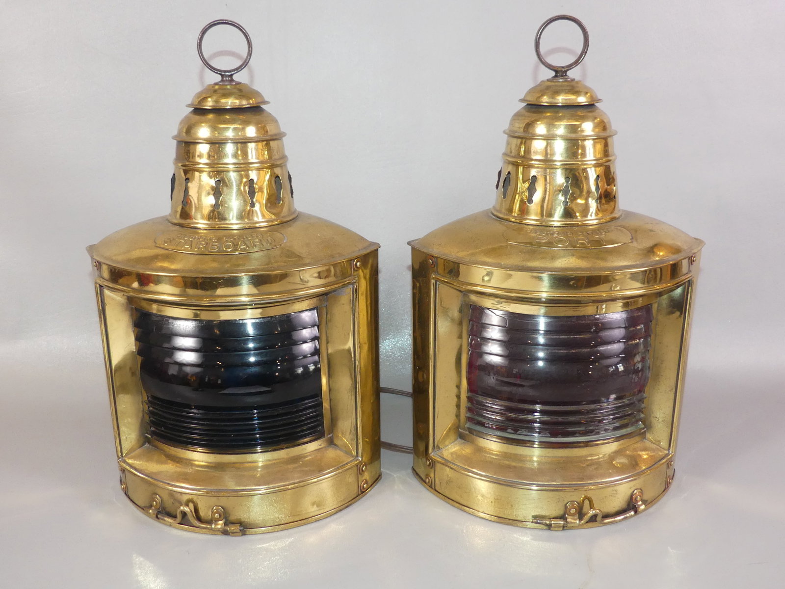 PAIR BRASS SHIP LANTERNS: Pair of vintage brass port/starboard ship lanterns, electric. 15 in tall.
