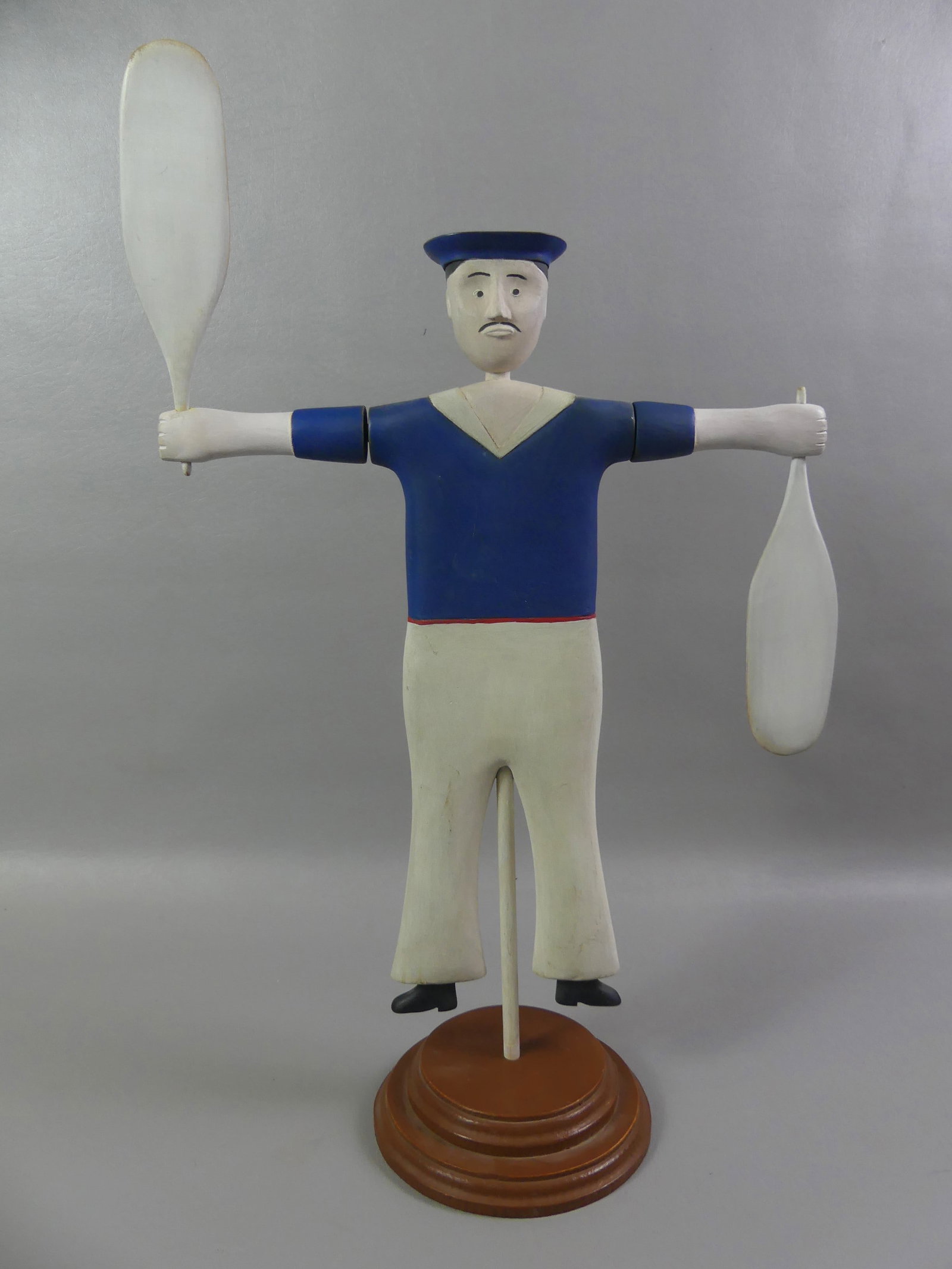 WHIRLIGIG OF SAILOR: Carved wood whirligig of a sailor on round base signed HA. 19.5 in tall