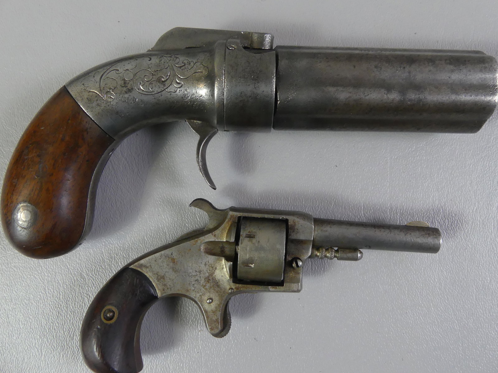 2 ANTIQUE POCKET PISTOLS: Lot 2 antique pocket pistols: 7.5 in long 6 shooter signed New York (attr. Allen & Thurber) with 22 caliber rotating barrel, engraved sidelock; 6 shot pepperbox with 2 in barrel stamped SPITFIRE, 5.5 
