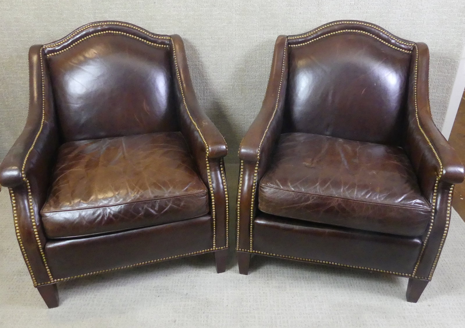 PAIR LEATHER CLUB CHAIRS: Pair vintage leather club chairs with brass tack trim in dark brown color signed Whittemore & Sherrill. 36 in high x 28 w x 29 d.