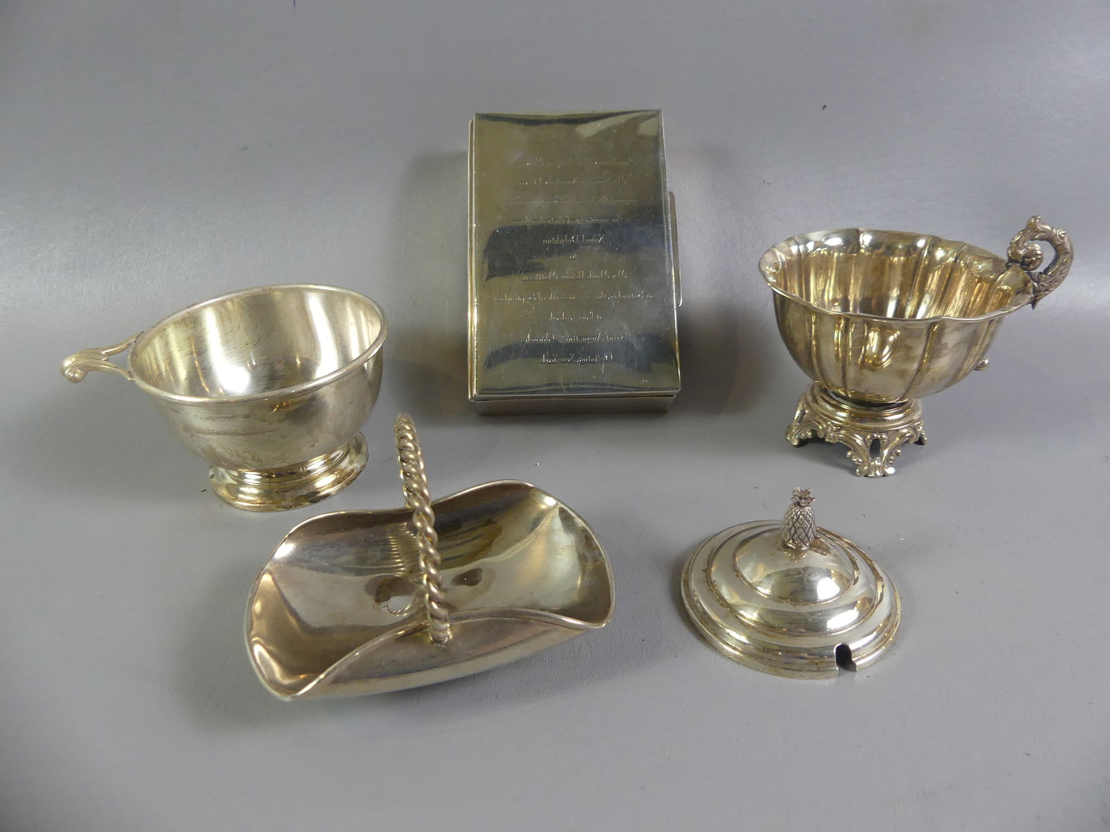 STERLING SILVER & CARTIER LOT: 5 piece sterling silver lot including: Cartier bowl with handle 3076; Cartier small footed basket 101; Cartier 6 in cigarette/card case 75 (wood lined); Cartier lid #3; French footed bowl with fancy h