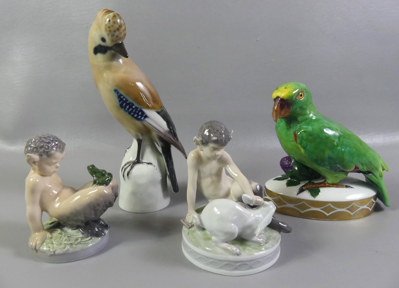 2 COPENHAGEN SATYR FIGURES & 2 BIRDS: Lot of 4 figurines: Two Royal Copenhagen Satyr or Pan figurines, one with bunny #439 and other a frog #1713 - both to 5.5 in tall. Plus a Hutschenreuther 6.5 in parrot and another bird with German hal