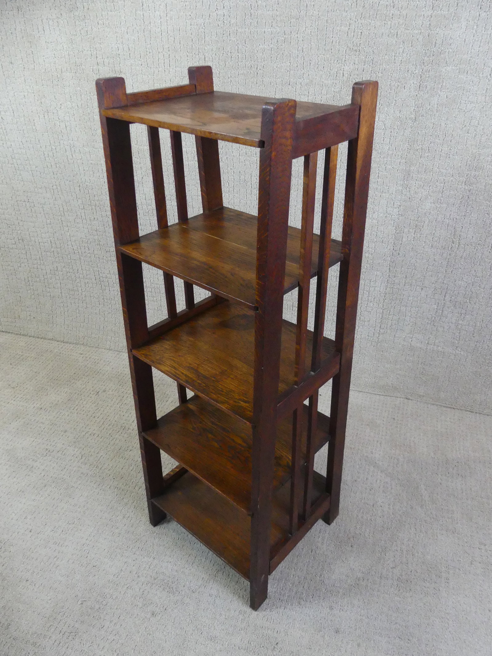ARTS & CRAFTS OAK BOOKSTAND: Old Arts and Crafts oak bookstand with 5 shelves and stenciled number on underside, possibly Stickley Brothers. 42 in tall by 10 d x 14 wide.