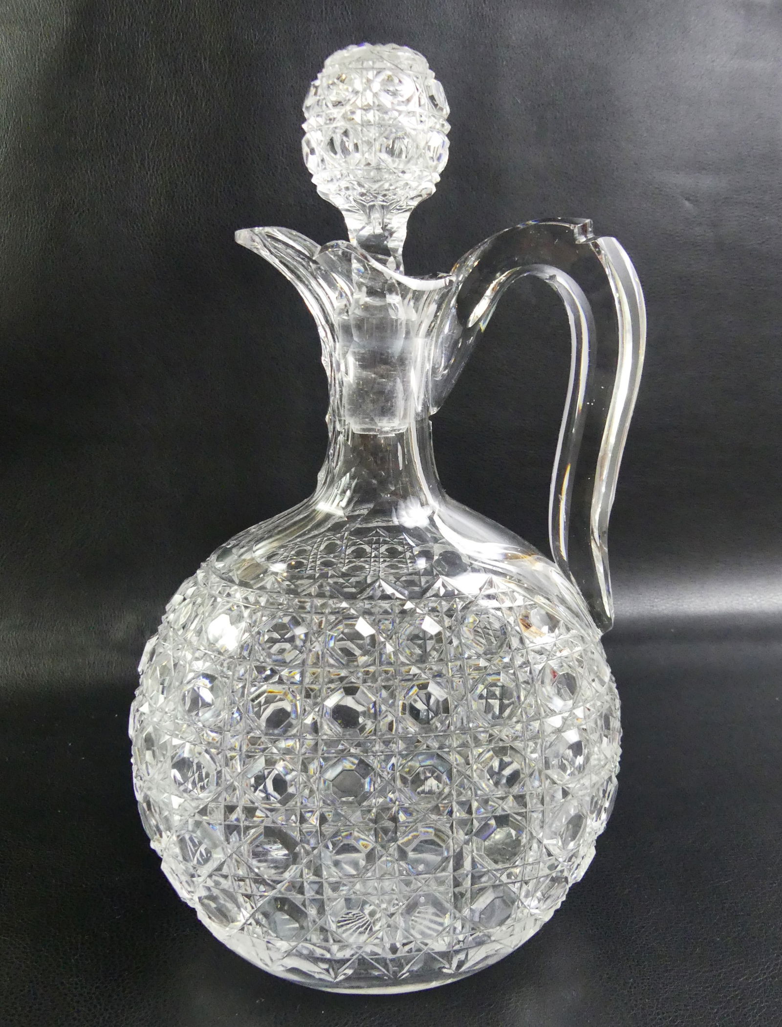 BRILLIANT CUT GLASS DECANTER: American Brilliant Period cut glass decanter or moon flask with flattened body and chair-bottom type cutting. Size: 10.75 x 5.75 in. VG with minor roughness on spout.