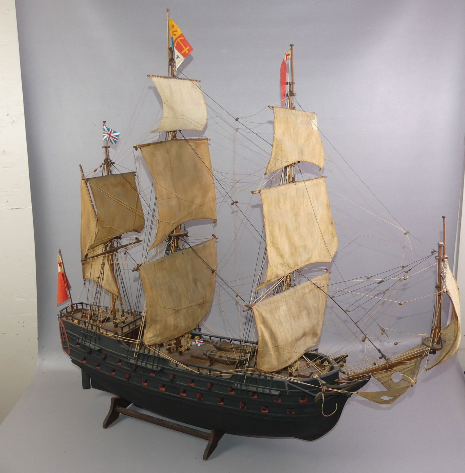 ANTIQUE BRITISH WAR SHIP MODEL: Fine old wood warship model of an English ship of the line with fabric sails. Solid hull. 42 x 42 x 7 in wide. Good condition.