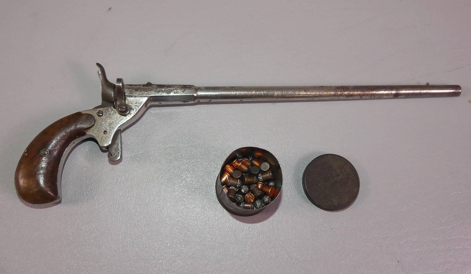 ANTIQUE GERMAN PARLOR PISTOL: Circa late 1800's parlor pistol with 10 in barrel attr. German. Has crowned B, G, and U hallmarks. 13 in long overall with original 6mm ammo in tin.