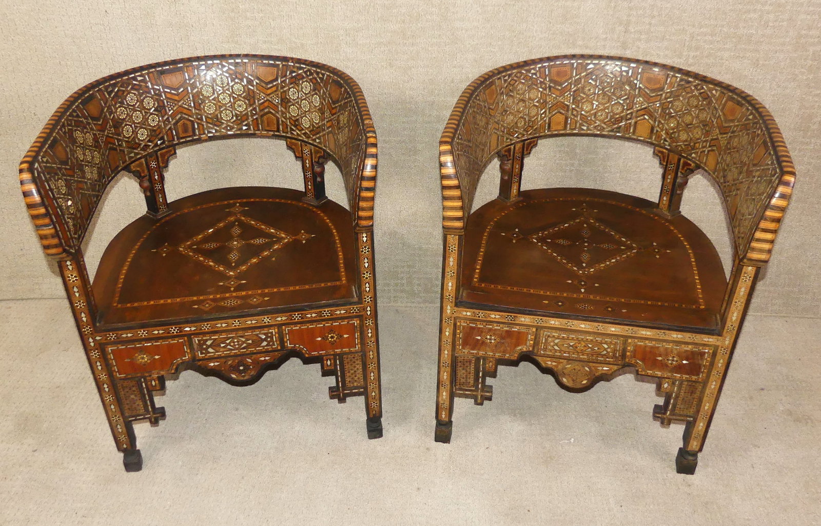 PAIR INLAID MOROCCAN CHAIRS: Pair of highly inlaid Moroccan barrel armchairs, 31 in high by 21 x 24 in. VG overall condition, may have some minor loss to inlay.