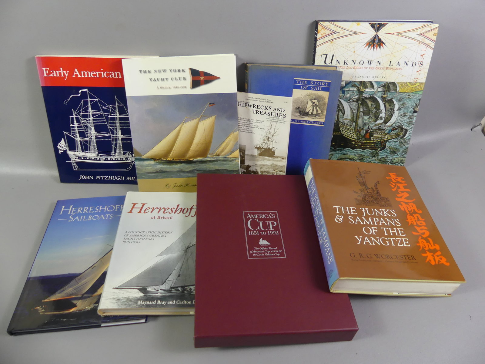 9 MARITIME RELATED BOOKS: Lot of 9 maritime related books (7 hardcover) including America's cup 1851-1992; 2 books on Herreshoff boats; The NY Yacht Club 1844-2008; The Story of Sail by Clowes 1936; Junks and Sampans of the Ya