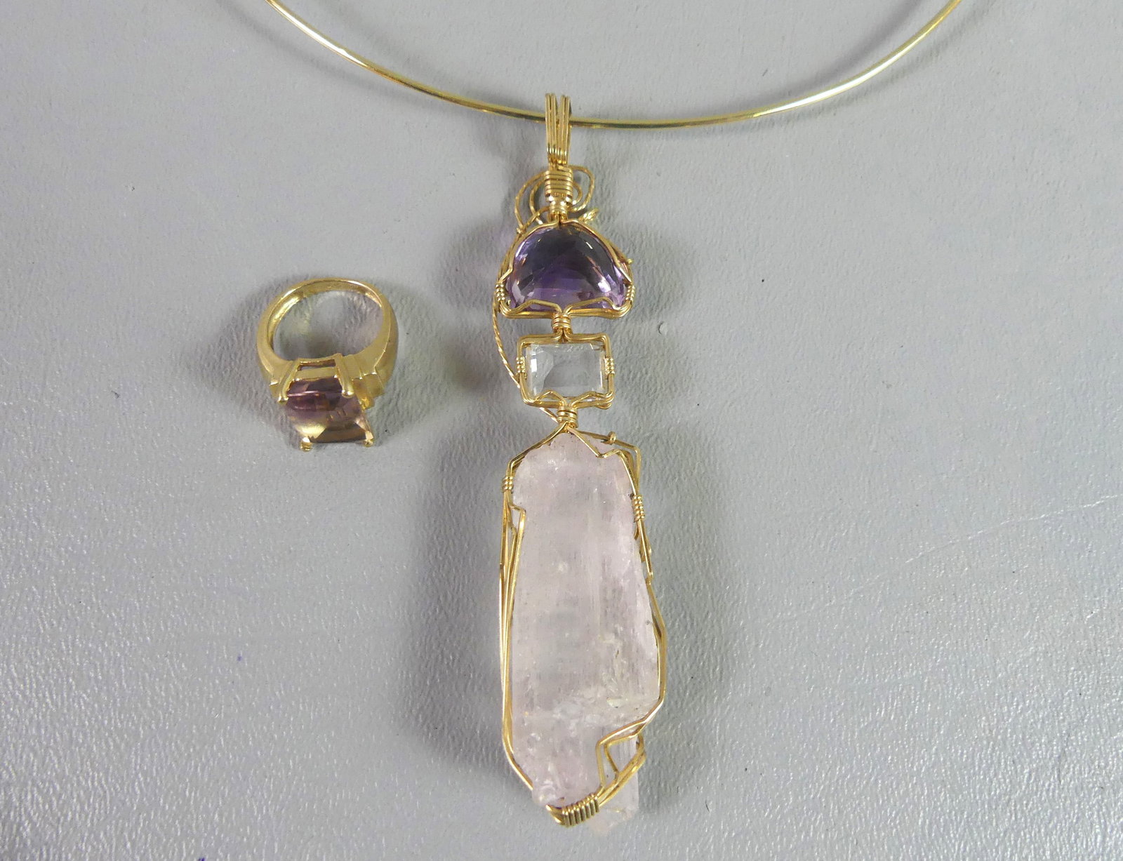 THREE 14K GOLD ITEMS: Lot 3 jewelry items in 14k gold: Amethyst ring, size 6, 3.7 dwt; choker with ringed design, 8.35 dwt; and 4 in long rough and polished amethyst pendant with gold wire mounts, 17.3 dwt.