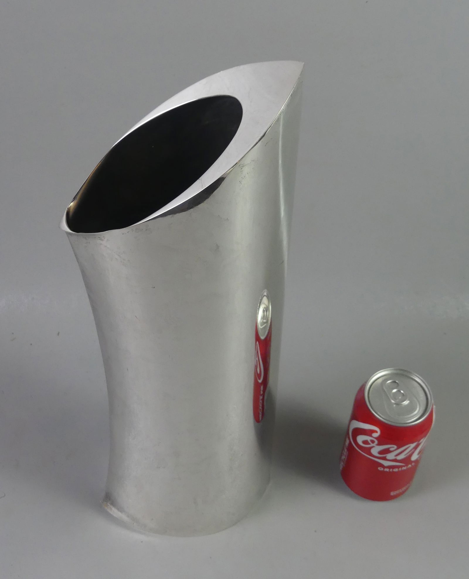 GUCCI LARGE MODERNIST STERLING VASE: Large and elegant sterling silver modernist vase signed Gucci, Made in Italy, 925. Size: 17.5 in tall x 5 x 3 in. Weighs 47.6 ozt. Small dimple on side, otherwise vg condition.