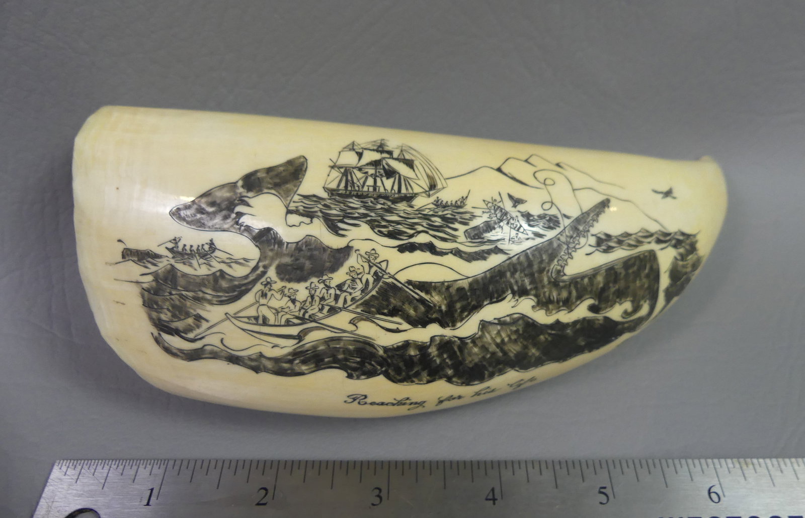 WHALE TOOTH - WHALING SCENE BY BEATTIE: Large antique whale tooth with later scrimshaw of a whaling scene titled Reaching For His Life, signed G.J. Beattie. 6.75 in long, weighs 21 oz.