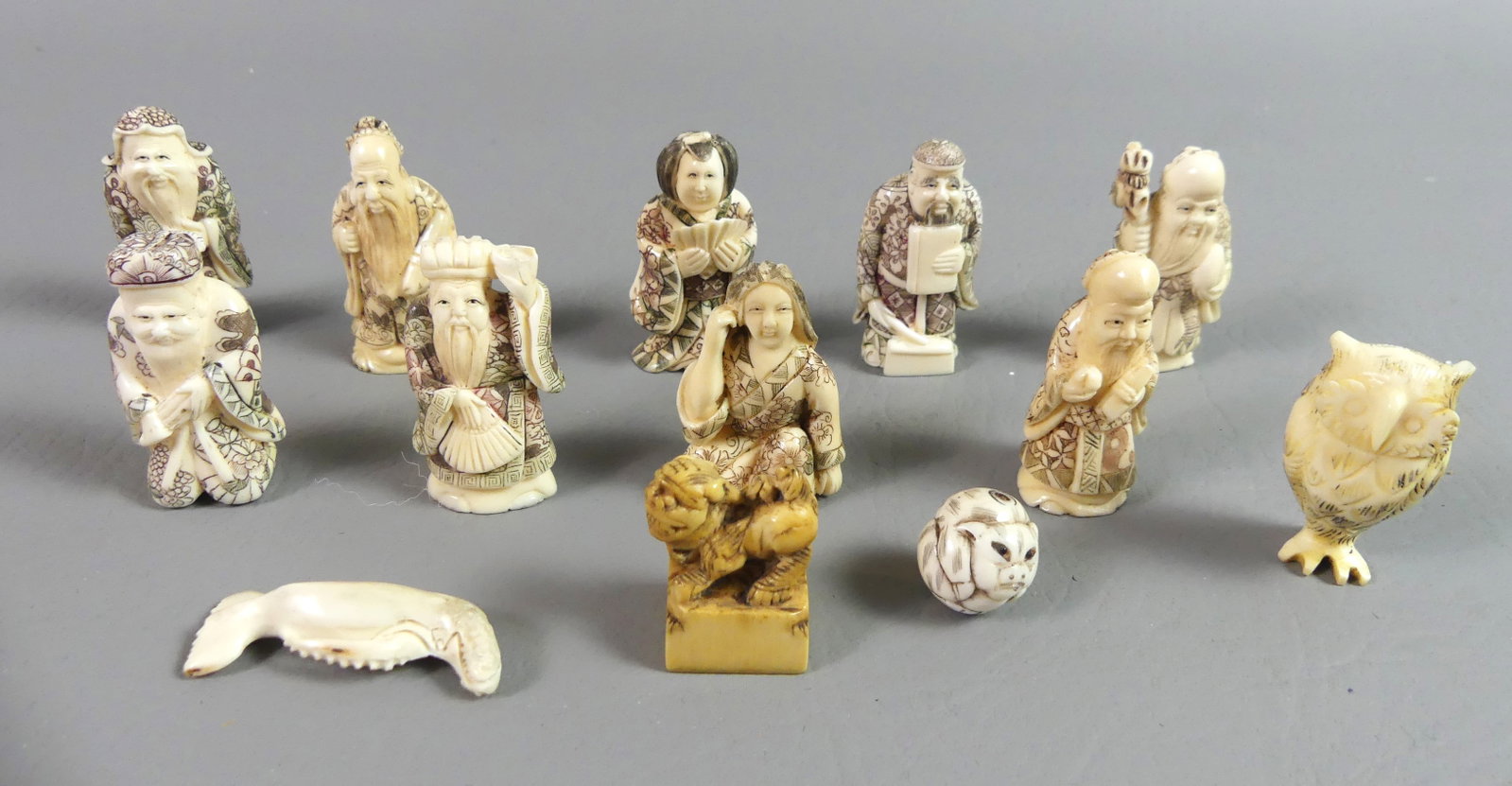 LOT 11 JAPANESE NETSUKES & STAMP: Lot of old Japanese carved bone netsukes and an Asian stamp, to 2 in tall. Mostly figural, some signed.
