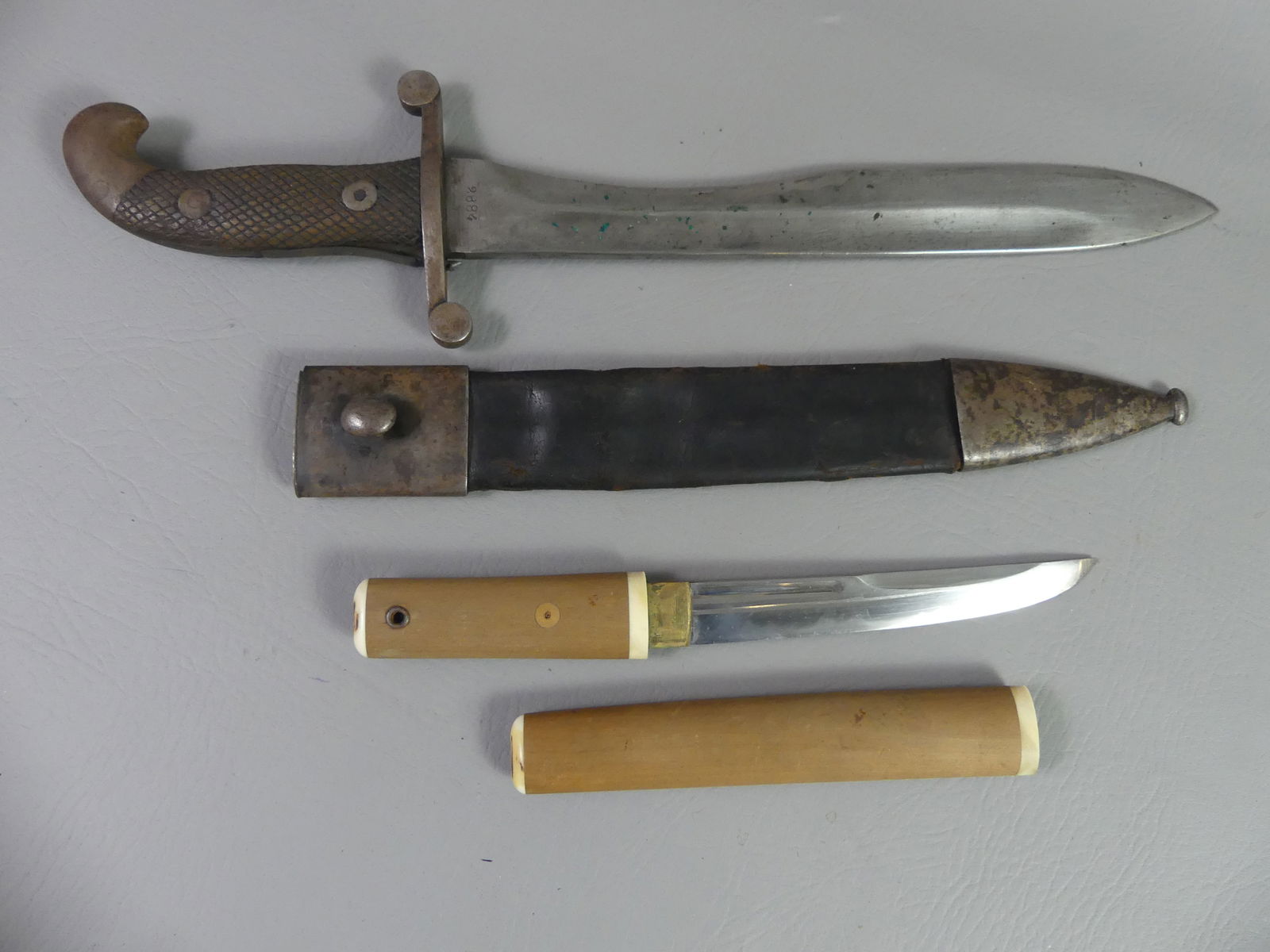 JAPANESE TANTO KNIFE & MILITARY DAGGER: A WWII era Japanese tanto knife (Seppuku or Harikari suicide ritual) with plain wood and bone handle and matching sheath. Very sharp knife with wavy hamon line, 10 in long overall. Plus an old militar