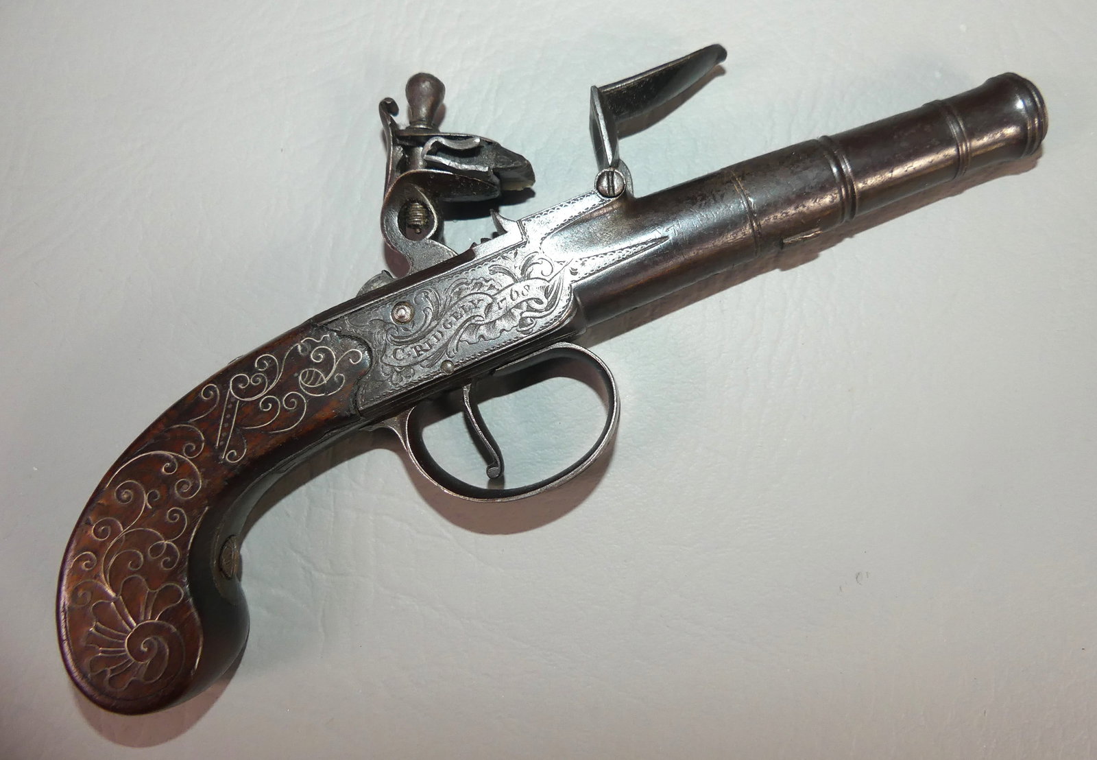 ENGLISH MUFF FLINTLOCK PISTOL - RIDGELY: English flintlock muff pistol with inlaid silver wire signed C. Ridgely 1768, 7.75 in long, about 45 caliber. Good mechanics.