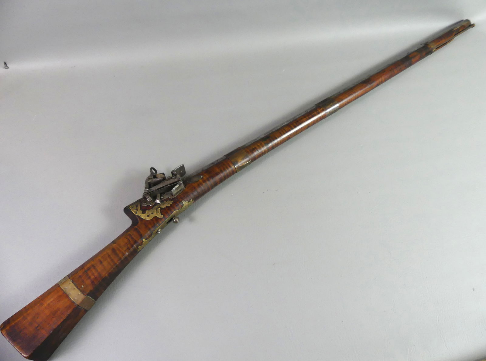 C. 1800 TIGER MAPLE TURKISH LONG GUN: Circa 1800 Turkish long gun with tiger maple stock and octagonal barrel, about 50 caliber. Engraved brass mounts. Overall 47.75 in, barrel 34.75 in. Good mechanics. Good mechanics.