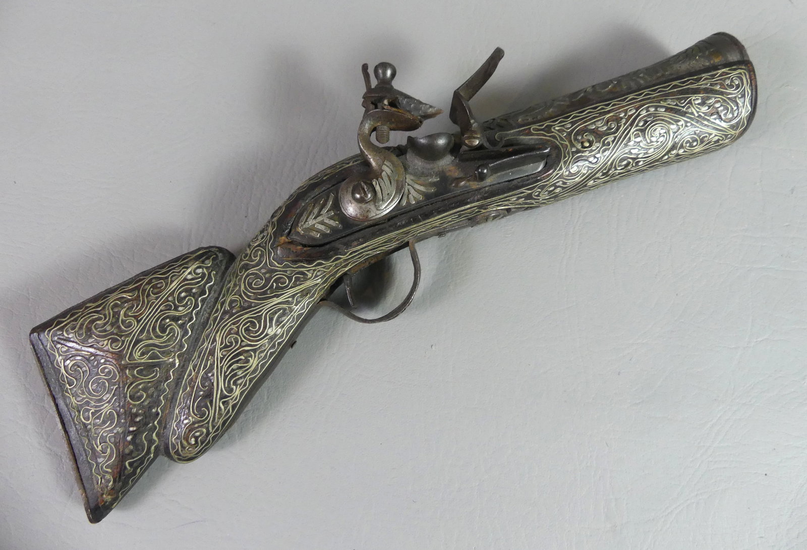 N. AFRICAN SILVER INLAID BLUNDERBUSS PISTOL: Ornate 19th century North African blunderbuss pistol with elaborate silver wire inlay. 12.5 in long, barrel 6 in, muzzle opening is 1.5 inches. Good mechanics.