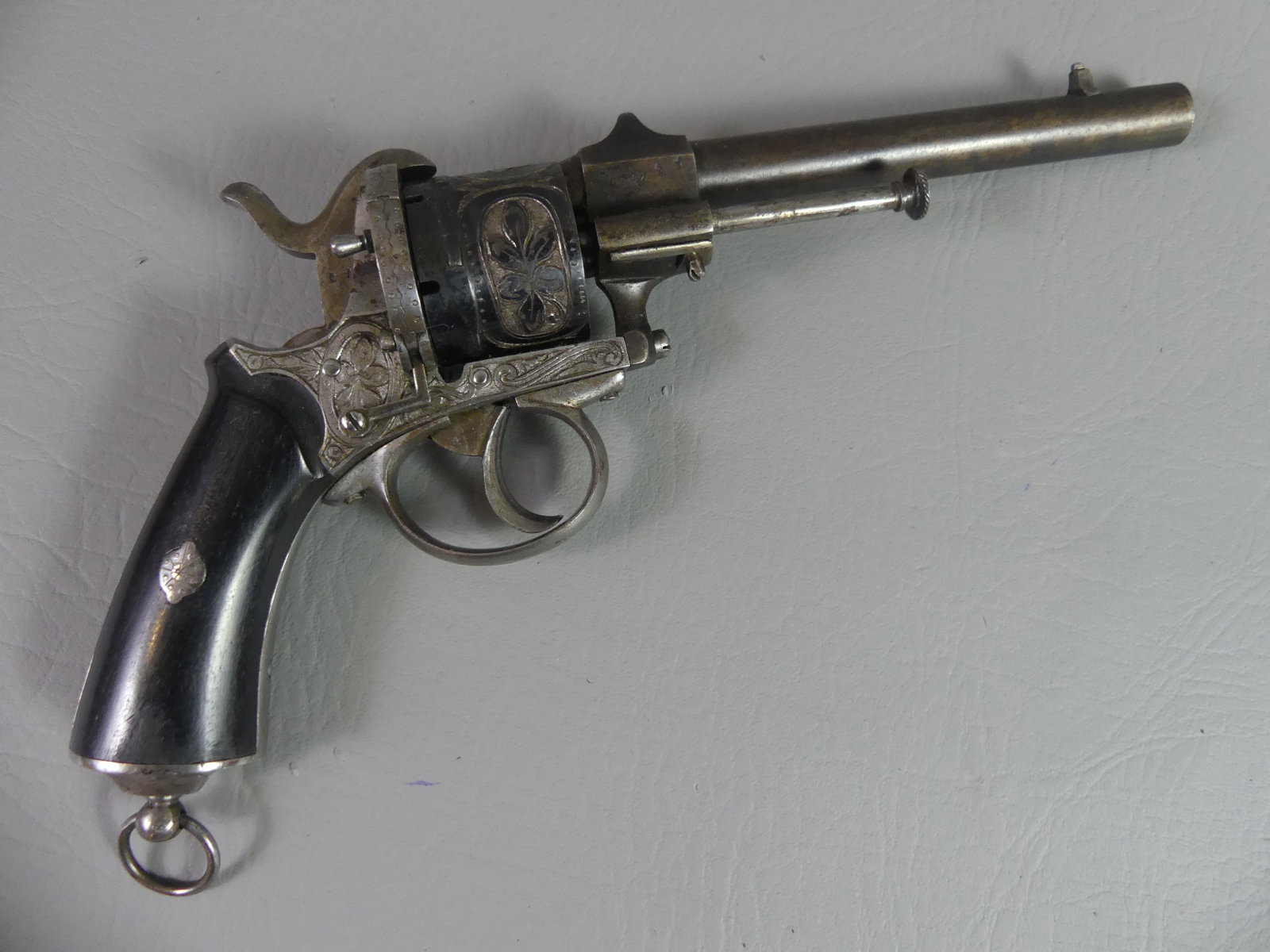 BELGIAN ENGRAVED PIN FIRE REVOLVER: Belgian 19th century pin fire revolver with ebony grips, heavily engraved floral designs. 10.5 in long, barrel 5.5 in, about 38 caliber. Good mechanics.
