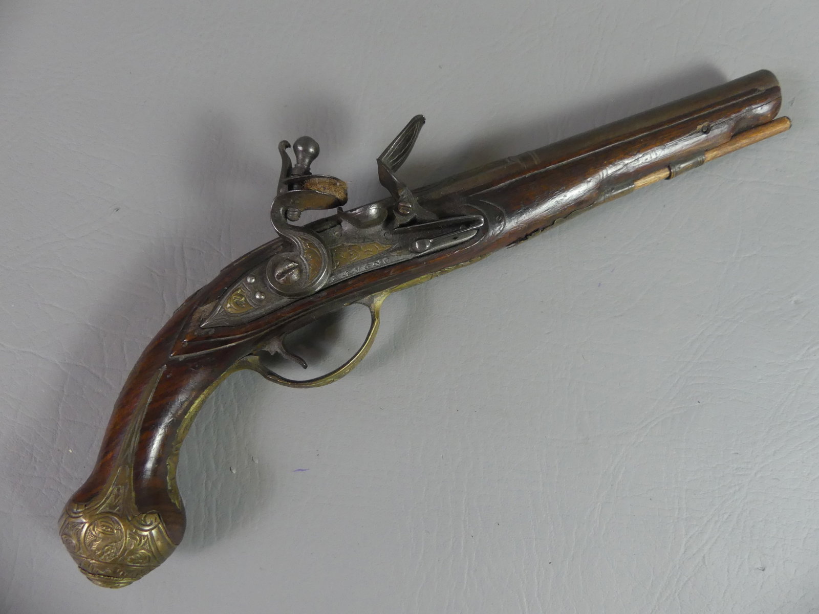 ITALIAN FLINTLOCK PISTOL BY G. LUGGIA: Circa 1700 Italian flintlock pistol with 8 brass portrait busts of a woman. Made by G. Luggia (not signed). 13 in long, barrel 7.75 in, about 50 caliber. Good mechanics.