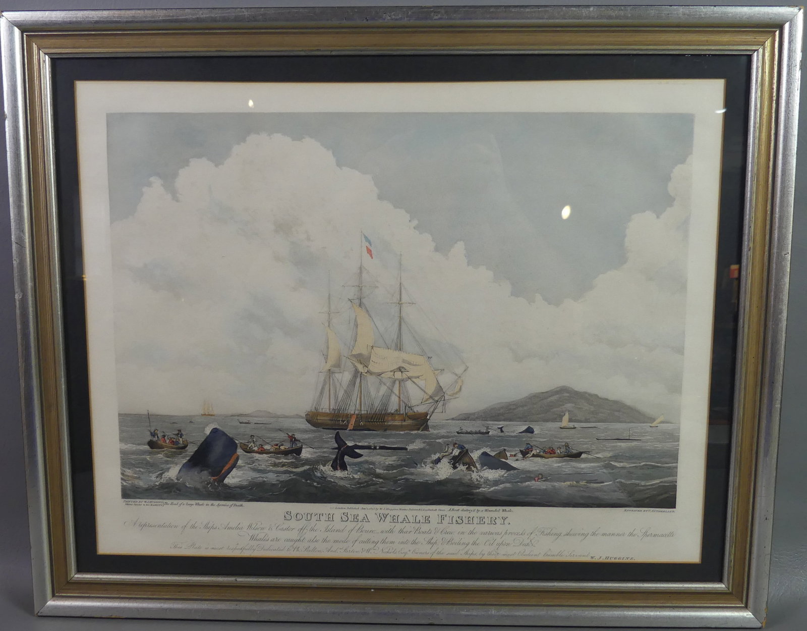 SOUTH SEAS WHALE FISHERY PRINT 1825: Antique colored print after Huggins, engraved by T. Sutherland in London 1825. Depicts a boat being destroyed by a whale. 16.5 x 21.5 in (sight), framed 21.25 x 26.25 in.