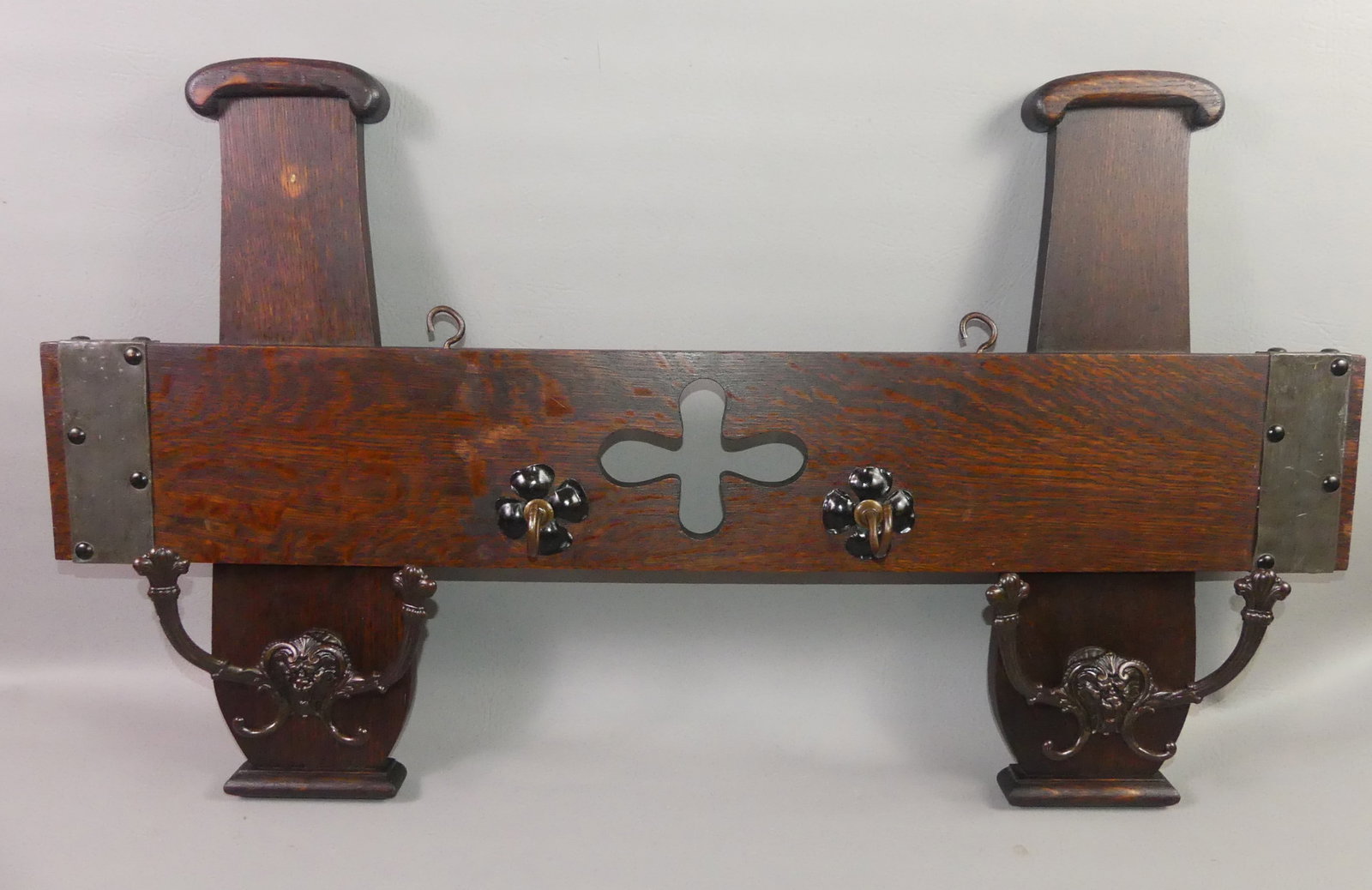 SHOP OF THE CRAFTERS OAK WALL RACK: Circa 1910 oak wall coat rack with 4 hooks signed with label verso --Shop of The Crafters, Cincinnati Ohio. Numbered 121. Original finish. 36 in long x 21 high.