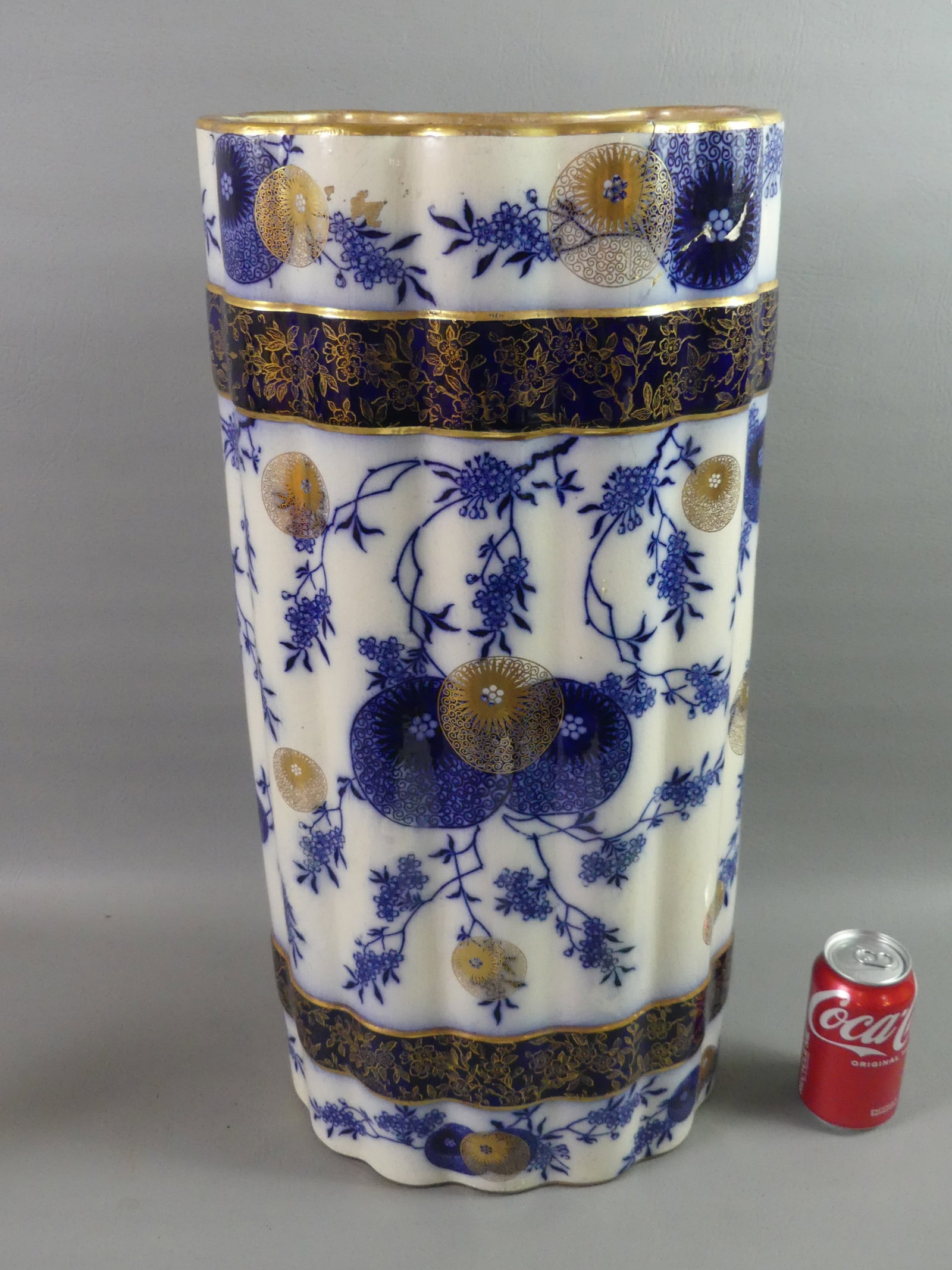 DOULTON BURSLEM UMBRELLA STAND: Unusual 19th century Doulton Burslem semi-porcelain umbrella / cane stand in a Japonesque bamboo design in blue and gold with circular symbols and flowering branches. 24 in tall x 11 x 8 in. Stamped o