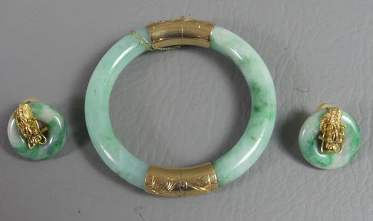 JADE & GOLD BRACELET & EARRING SET: 3 pieces of Chinese green jade and gold jewelry: 3 in circular bangle bracelet and pair of one inch circular earrings with dragons and gemstone eyes.