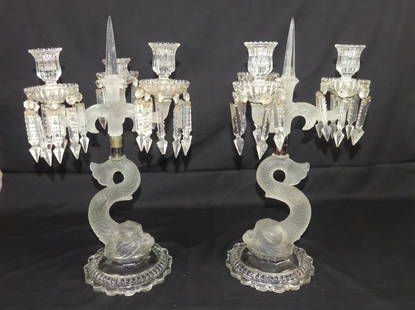 PAIR BACCARAT DOLPHIN CANDELABRAS: Pair of Baccarat 3 light crystal candelabras with large dolphin bases. They have colorless and frosted portions with cut glass prisms (some chipped and few missing). One candleholder has been