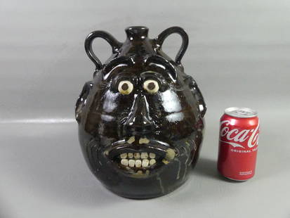 H. FERGUSON ART POTTERY FACE JUG: Vintage art pottery face jug in dark brown drip glaze signed Harold Ferguson 8-18-03. 11 in tall. VG condition.