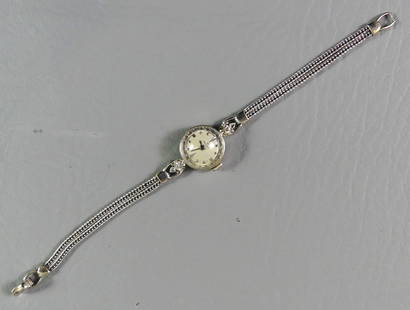 ROLEX 14K GOLD LADIES WATCH: 14K white gold ladies watch by Rolex with 14k gold bracelet. Has 2 small diamonds. Case is 1/2 in diameter. Weighs 8.2 dwt, size 6 manual wind.