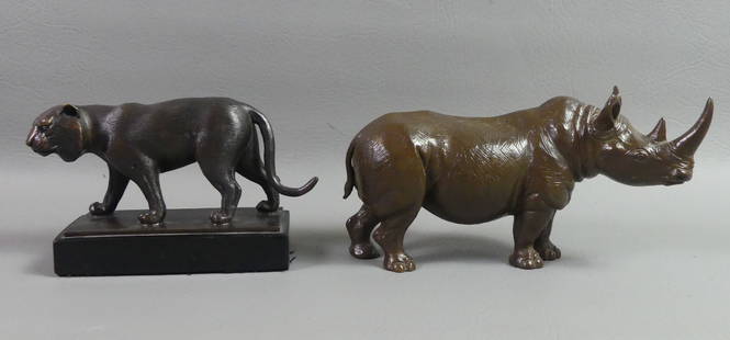 BUSTAMANTE BRONZE LIONESS & RHINO: Lot of 2 animal sculptures: Bronze figure of a stalking lioness on black stone base signed Sergio Bustamante 20/100, 7 in long and 4 in high; and unsigned bronze or patinated metal figure of a