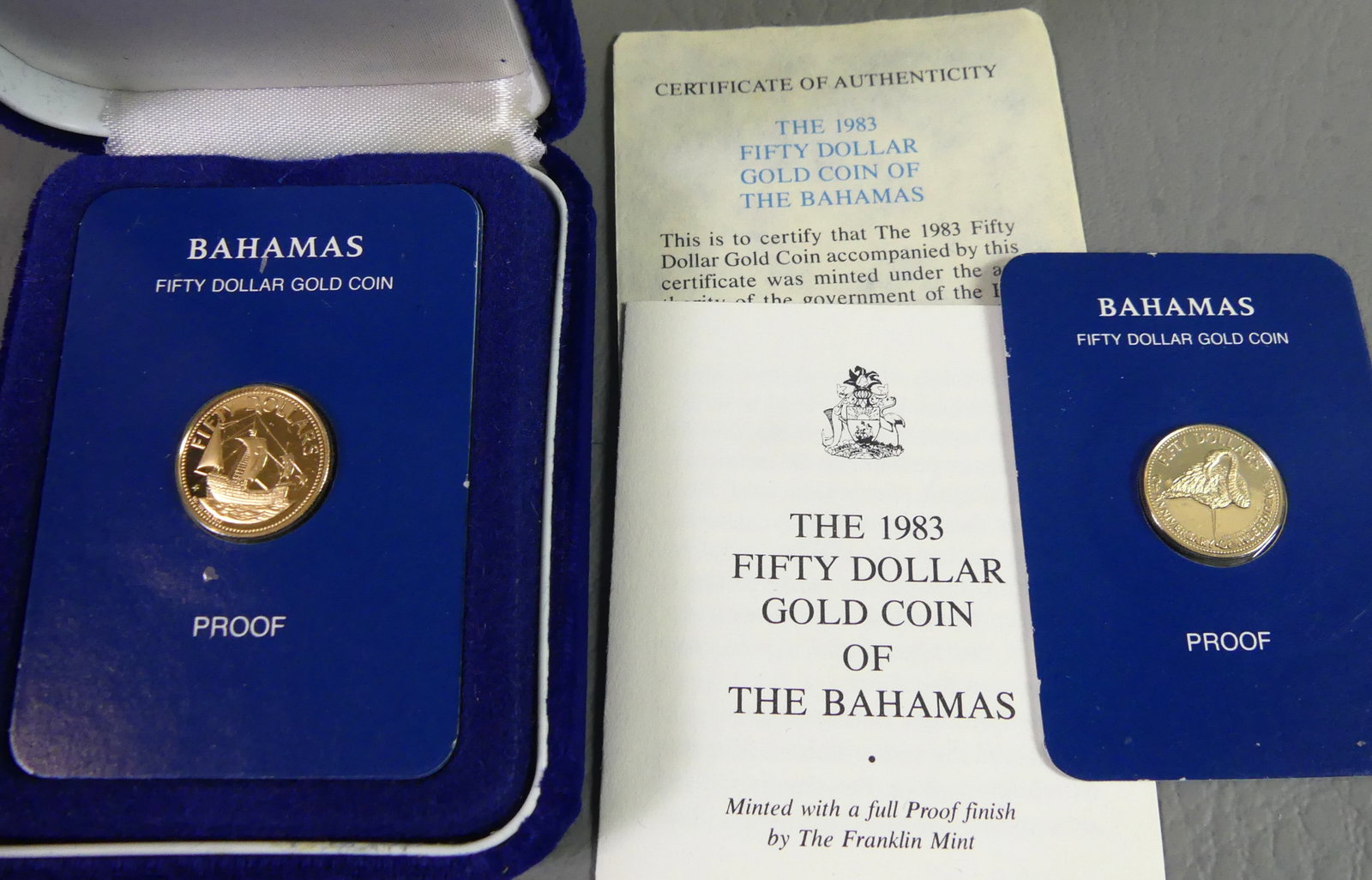 2 BAHAMAS $50 GOLD COINS: Lot of 2 $50 gold proof coins from the Bahamas for 1983 and 1985, one in case. Contains .500 fine gold. 15.8mm