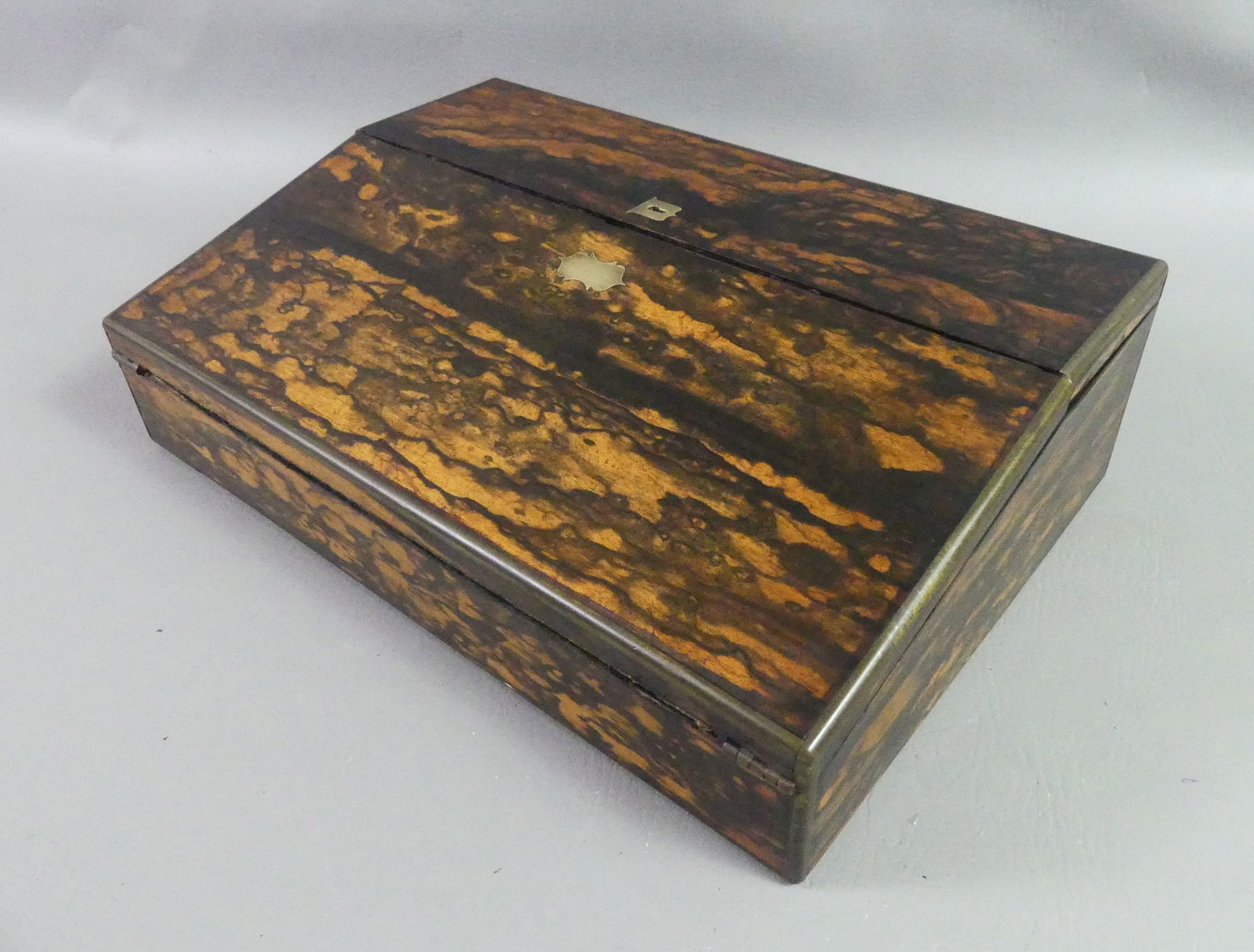 ANTIQUE COROMANDEL LAP DESK: Fine Victorian brass-mounted coromandel lap desk with flip-down writing surface, 2 interior drawers (one missing), and compartment for inkwells and pens. 15 x 10 x 4.5 in.