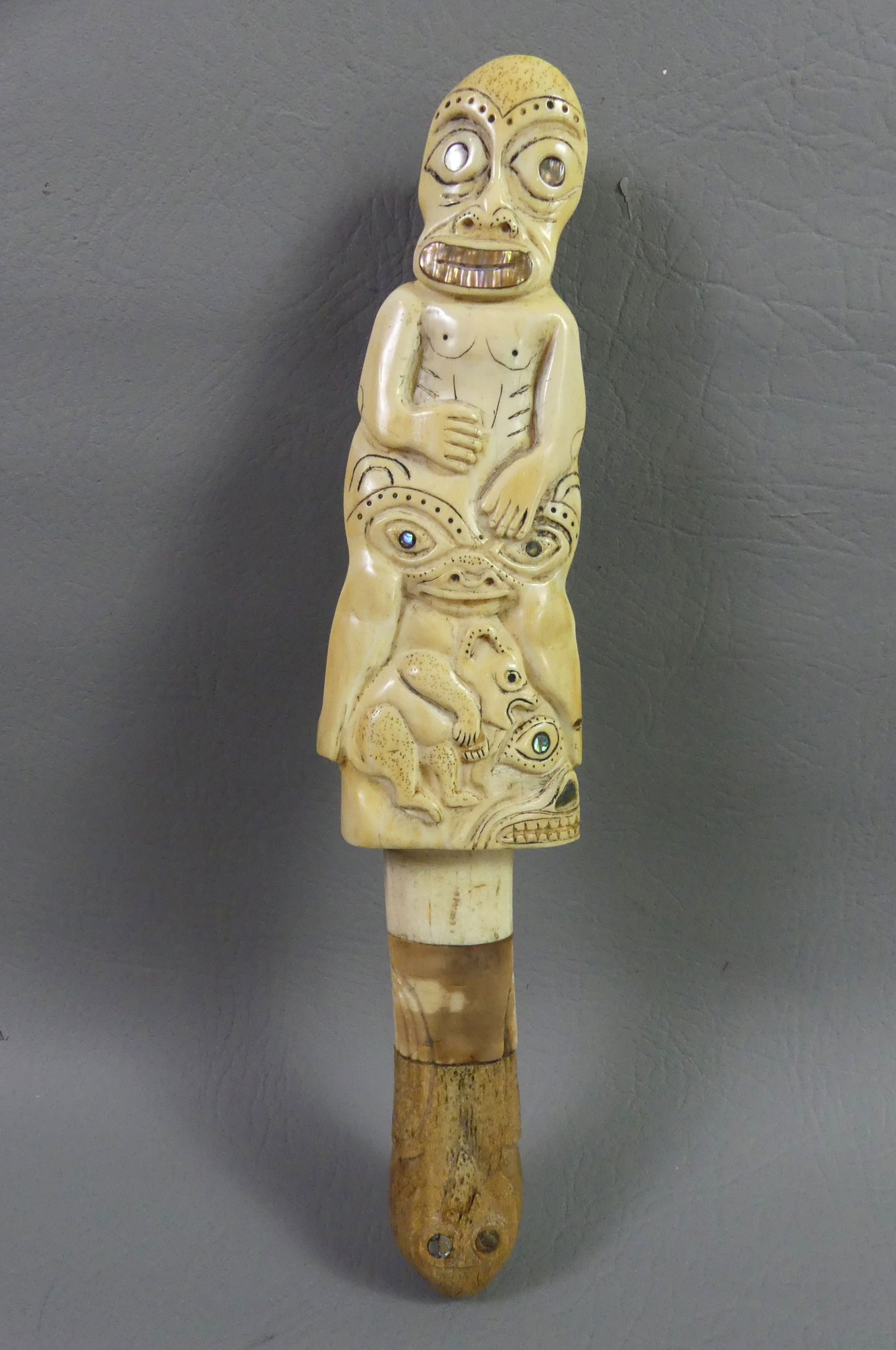 POLYNESIAN FIGURAL BONE RATTLE: 19th century Polynesian carved bone rattle with 3 grotesque figures. 11 x 2.5 in wide.