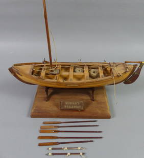 MORGAN'S WHALEBOAT MODEL: Small old wood model with oars and accessories, plaque titled MORGAN'S WHALEBOAT. 12 in long x 3 x 2, not including wood stand.
