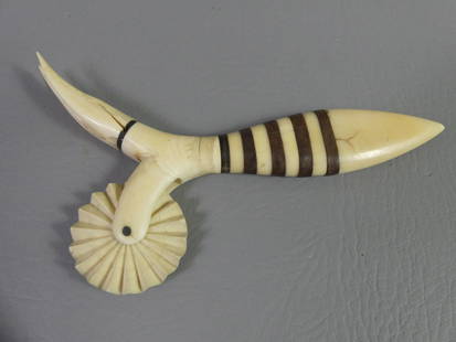 WHALEBONE PIE CRIMPER: 19th century whalebone pie crimper or jagging wheel with 5 baleen strip and 3 tine fork. Couple minor cracks, 7 in long