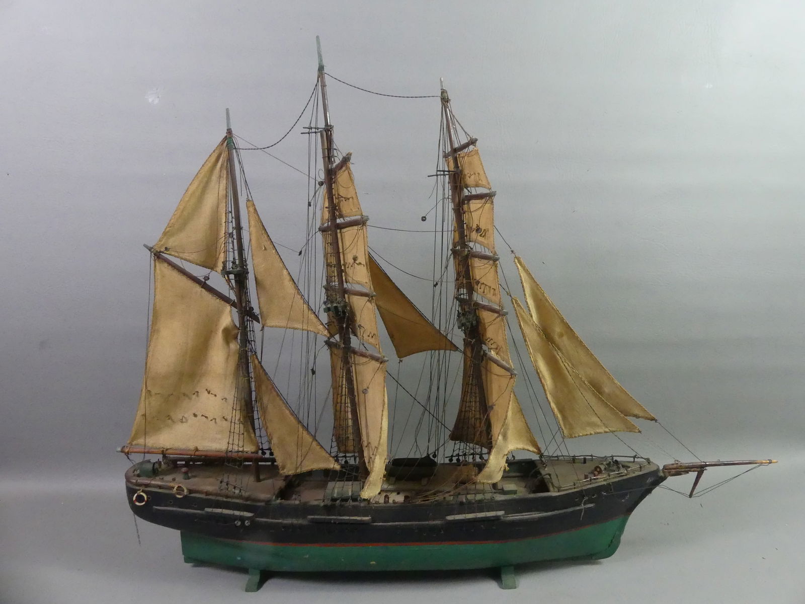 ANTIQUE SHIP MODEL: Antique painted wood 3 masted ship model with cloth sails. 29 in long x 24 in high. Good condition.