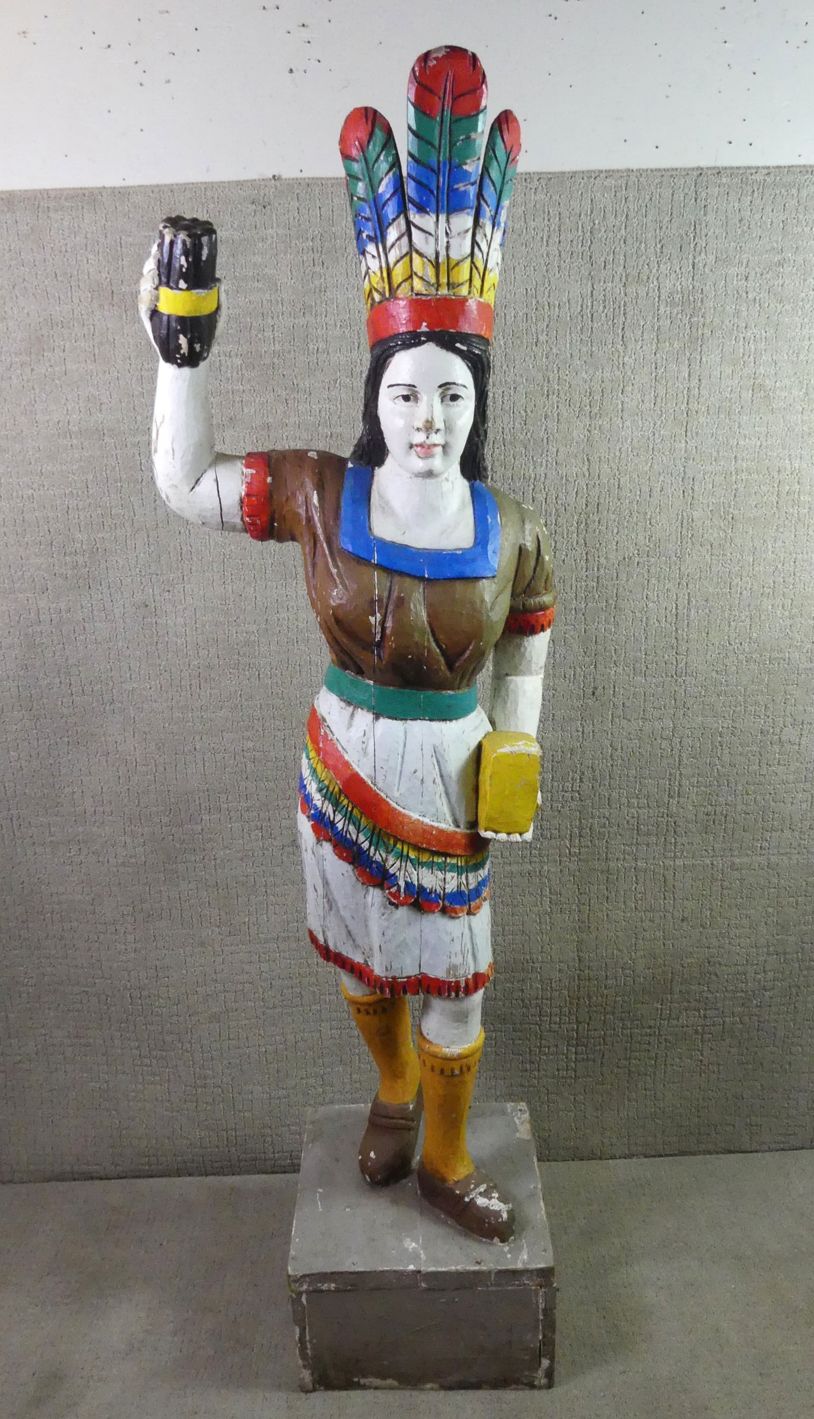 6 FT. OLD CIGAR STORE INDIAN: Old 20th century carved and painted cigar store Indian figure. 6 ft tall x 16 in square on base. Has been repainted.