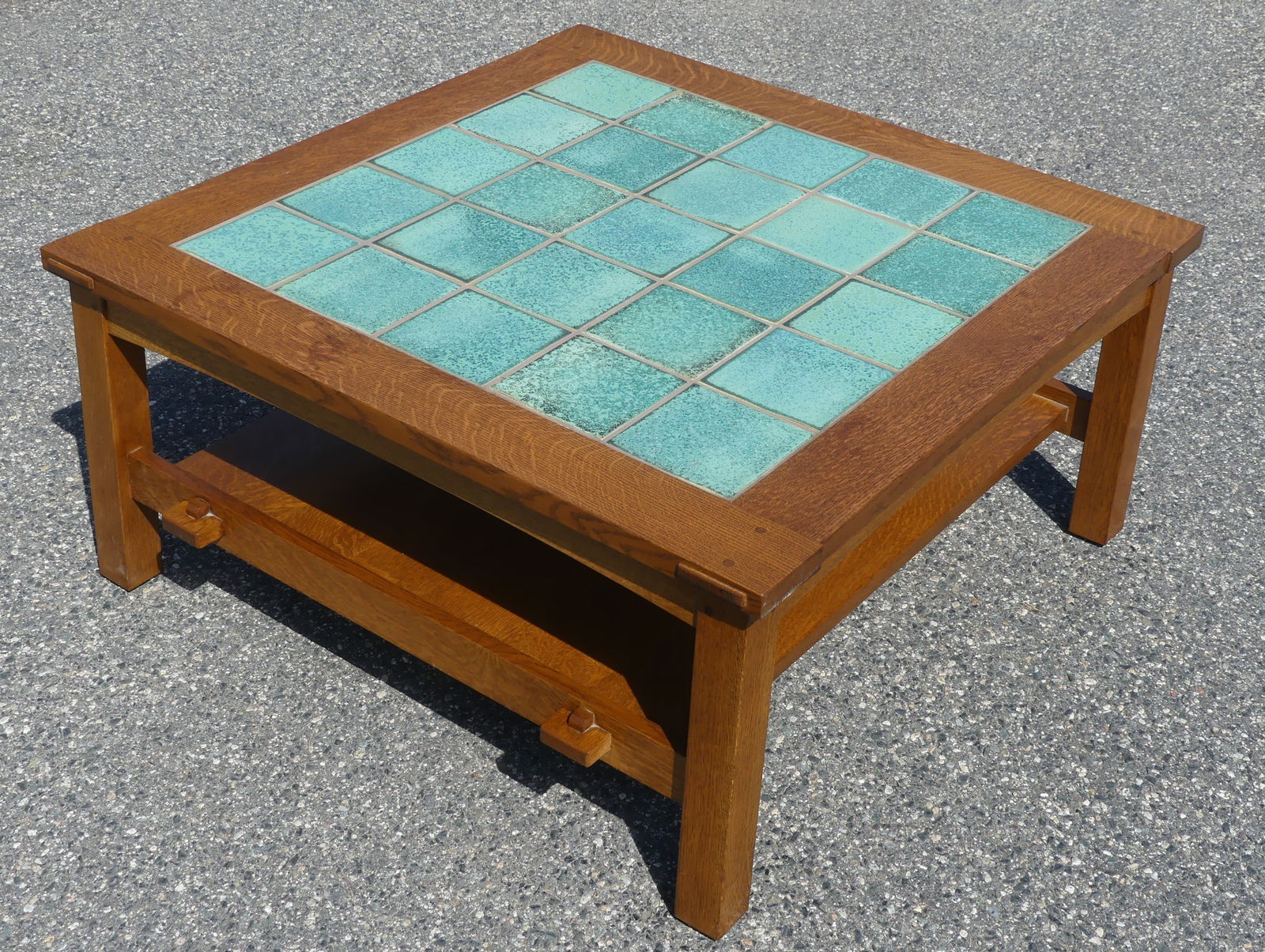 STICKLEY TILE TOP COFFEE TABLE: Vintage Stickley of Manlius NY solid oak coffee table with green art pottery tile top. Signed on underside with date of 1995 and numbers 89-579 and #35. 38.5 in square, 18 in tall.