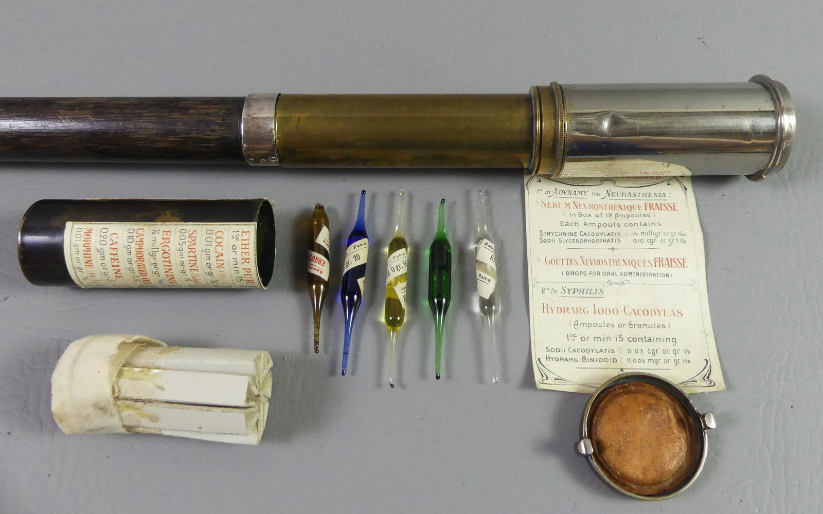RARE FRENCH DOCTOR CANE 1855: Rare French doctor's cane in brass and metal with wooden shaft with engraved name of ED Scott. The twist off handle in form of a container holding 5 small glass medicine vials (one chipped) and printe