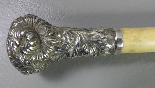WHALEBONE & SILVER WALKING STICK: Fancy repousse sterling silver (stamped) repousse floral cane with tapered whalebone shaft. 36 in long.