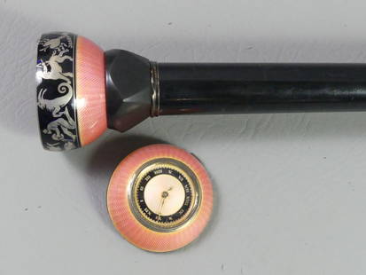 RARE FRENCH ENAMEL CLOCK CANE: Rare French enameled clock cane with hinged top to reveal compartment. It has pink enamel on sterling with signs of the zodiac. Ebony shaft with sterling ferrule, 36 in long. Clock not running and