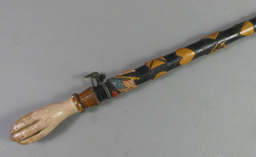 CIVIL WAR PATRIOTIC CANE: Wonderful folk art Civil War memorial cane with painted and carved designs including flag, corps symbols, USA, and dates 1861-1865. Handle is in form of a fist holding ball. 34.5 in long.