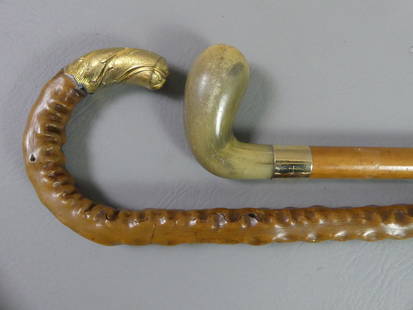 2 FANCY GOLD CANES: Lot 2 fancy gold handled canes: Club-shaped animal horn with stamped 14k gold collar engraved John J. Mitchell, Chicago - has cocabola shaft 34.5 in long; and shepherd hook cane with knobby wood