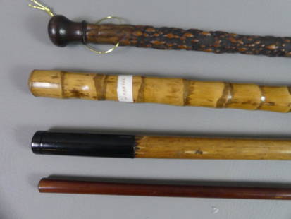4 ASSORTED WALKING STICKS: Lot of 4 assorted walking sticks to 36.5 in long: fine thin mahogany; heavy bamboo marked WHANGEE; oak and black metal; and rootwood with knob.