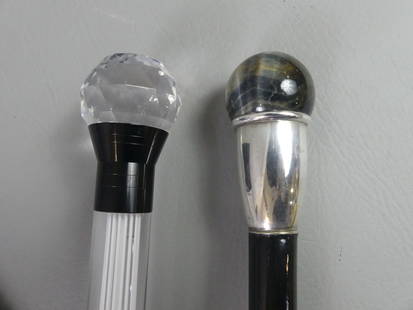 2 WALKING STICKS: FLASHING & AGATE: Lot of 2 walking sticks: vintage battery-operated plexiglass cane with wood shaft that lights up red when tapped, 37 in; and a carved agate 1.75 in diam ball-top with silver collar and ebony shaft,